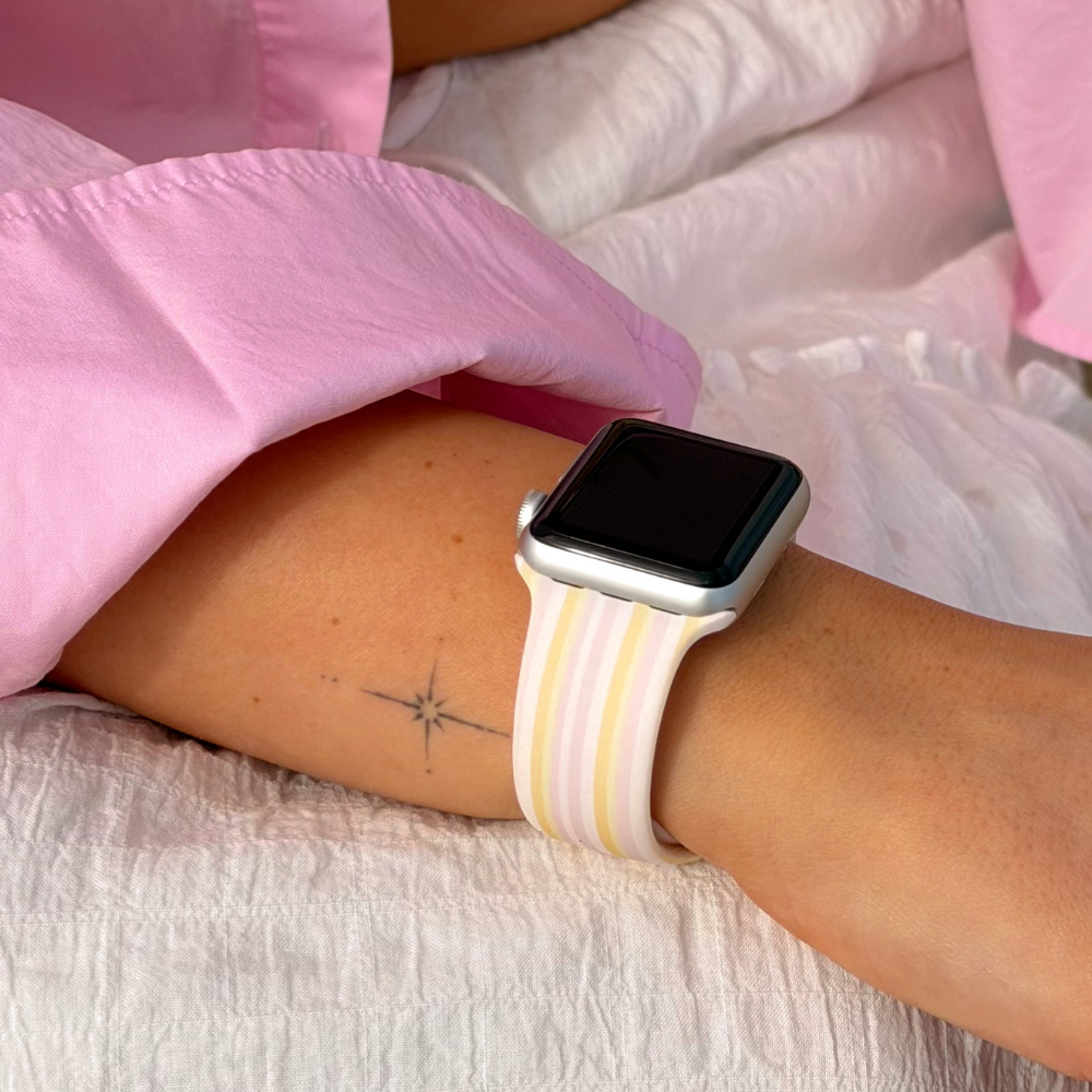 Close up of pastel stripes apple watch strap on girls white skirt