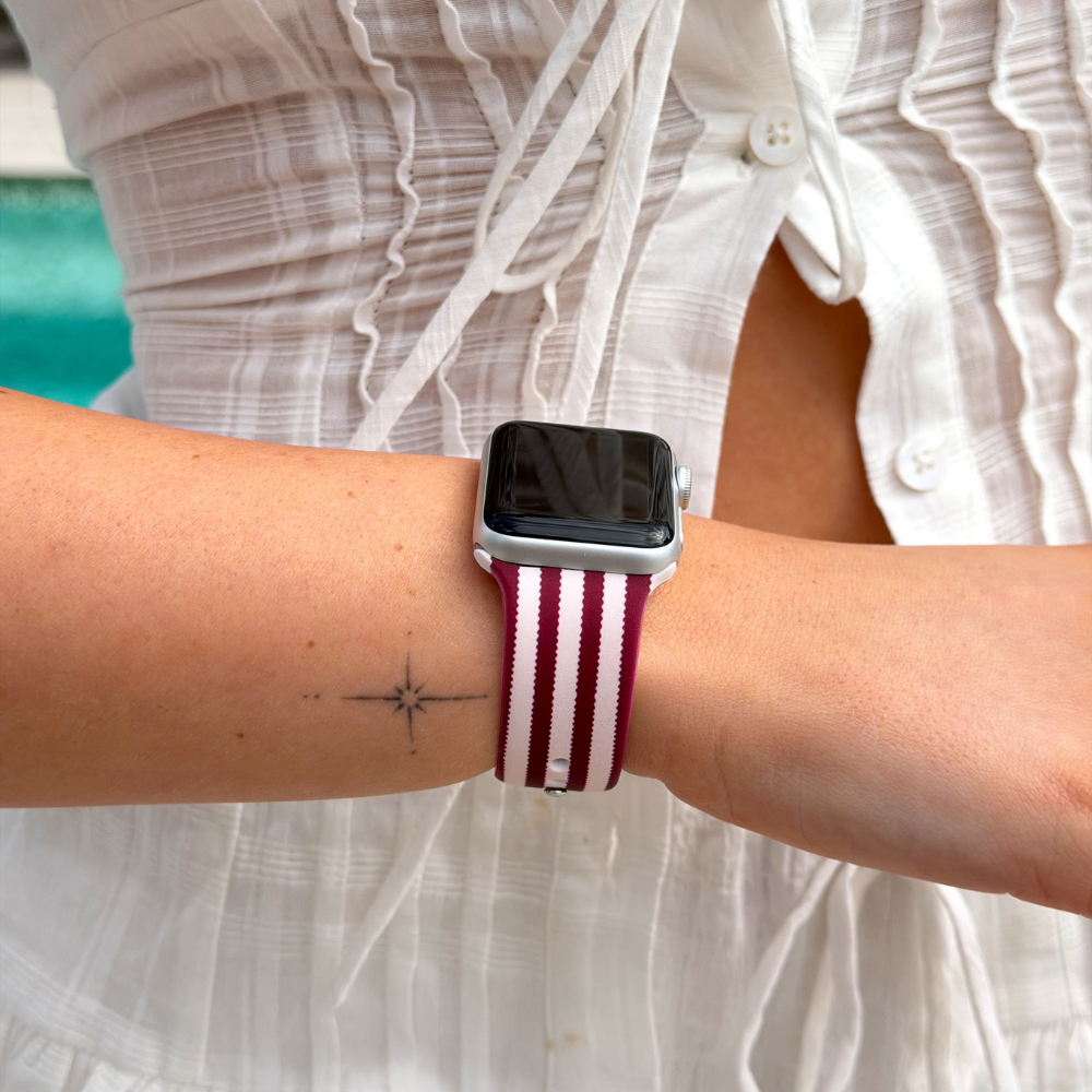 Close up of the Blushberry Scallop Stripes Watch Strap on a girls wrist wearing white top and skirt