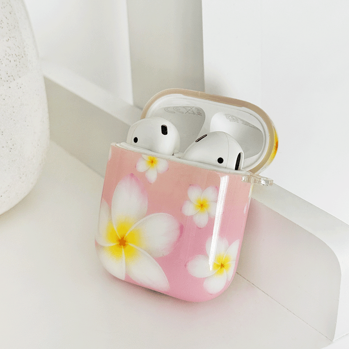 Pink AirPods Case with white hibiscus flower design.
