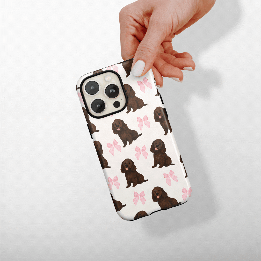 GIF showing a white phone case with dogs and pink bows