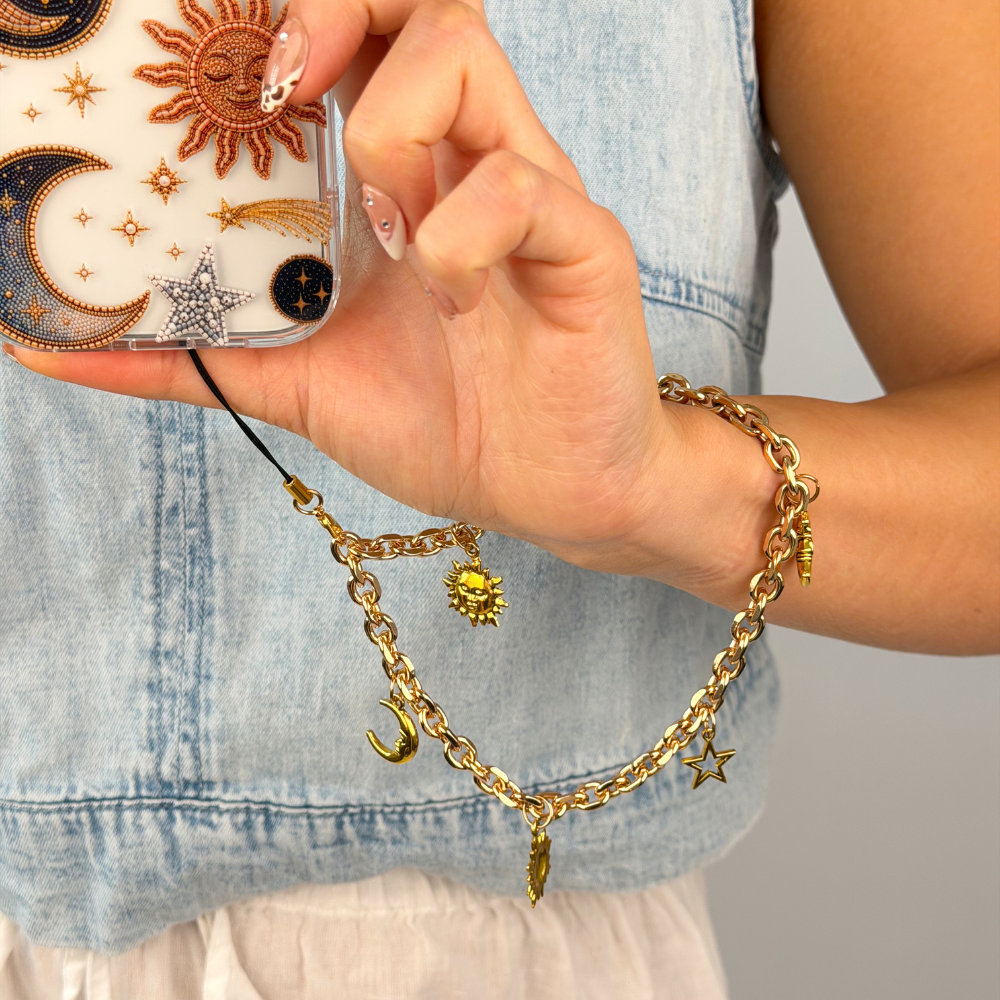 celestial gold phone strap on wrist