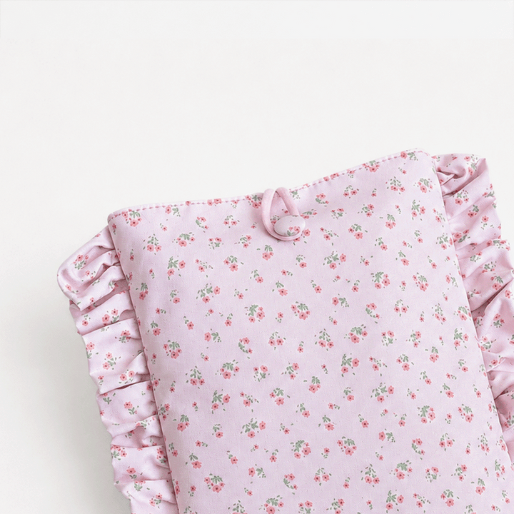 Pink floral patterned Book Sleeve with ruffled trim.