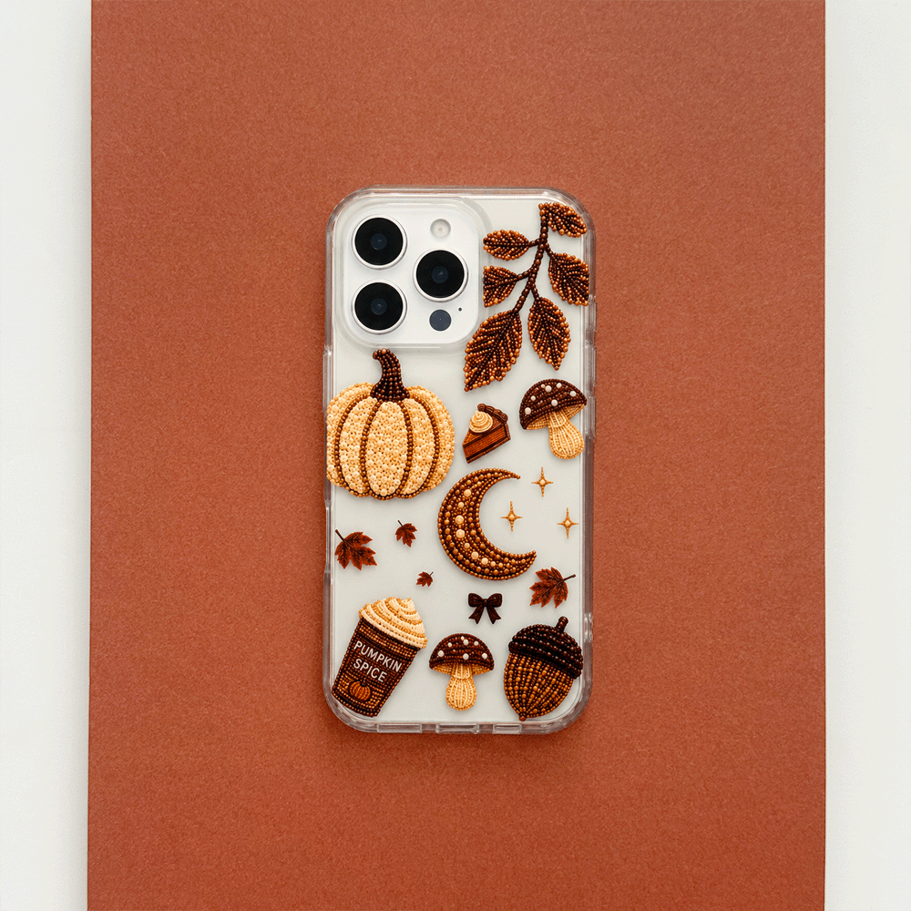 A clear phone case decorated with autumn-themed graphics including a pumpkin, moon, mushrooms, acorns, stars, and leaves.