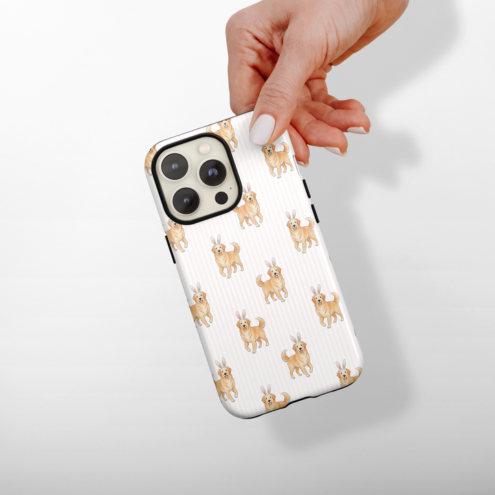 Phone case with dog pattern held by a hand on a white background