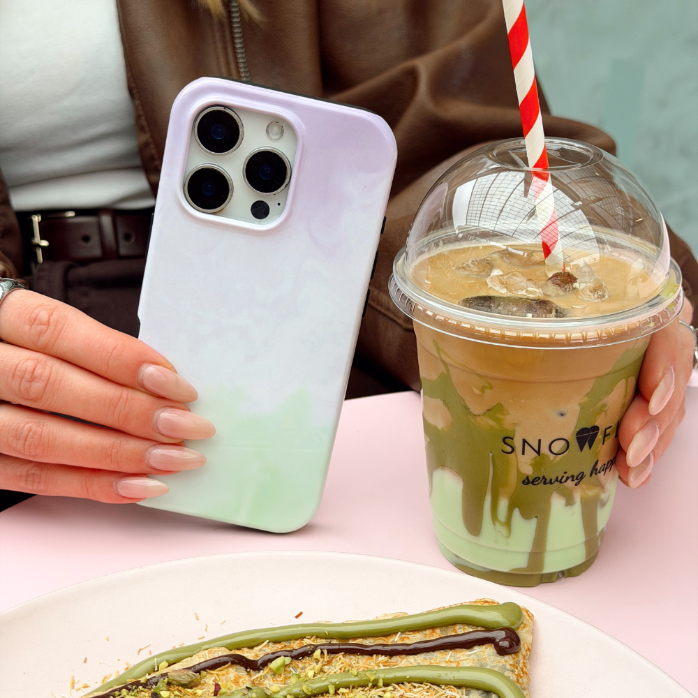 A photo of Lavender Tough Phone Case next to an iced latte