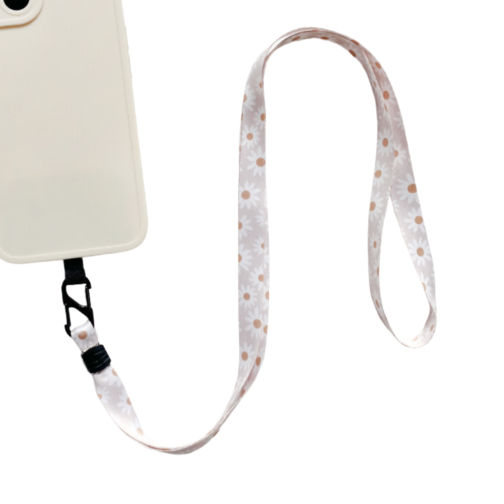 A stylish phone accessory from Coconut Lane, the Universal Phone Lanyard Patch Bundle features a cream-colored smartphone case paired with a floral lanyard adorned with daisy patterns. The patch loops and extends from the bottom of the case, enhancing phone security. The product image is set against a white background.