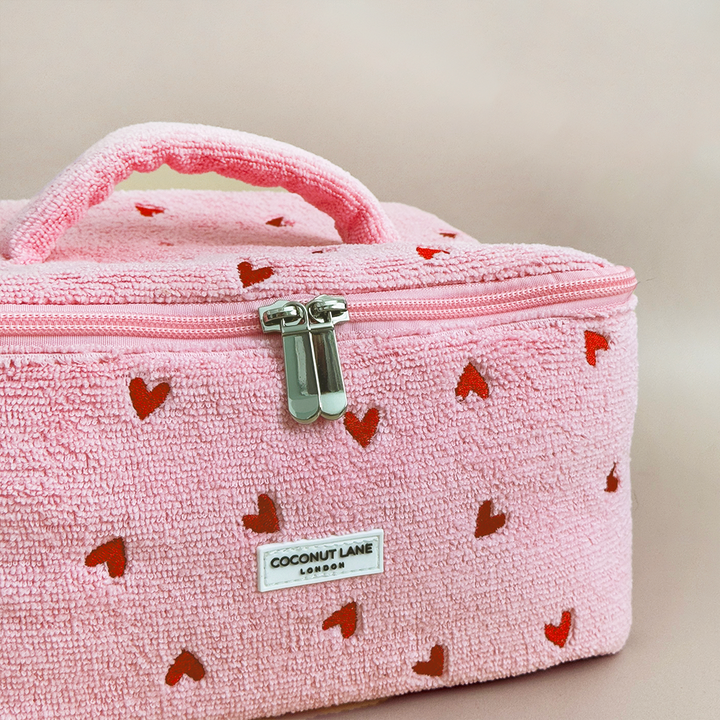 Pink textured beauty box with red heart patterns and 'Coconut Lane' branding on a beige background