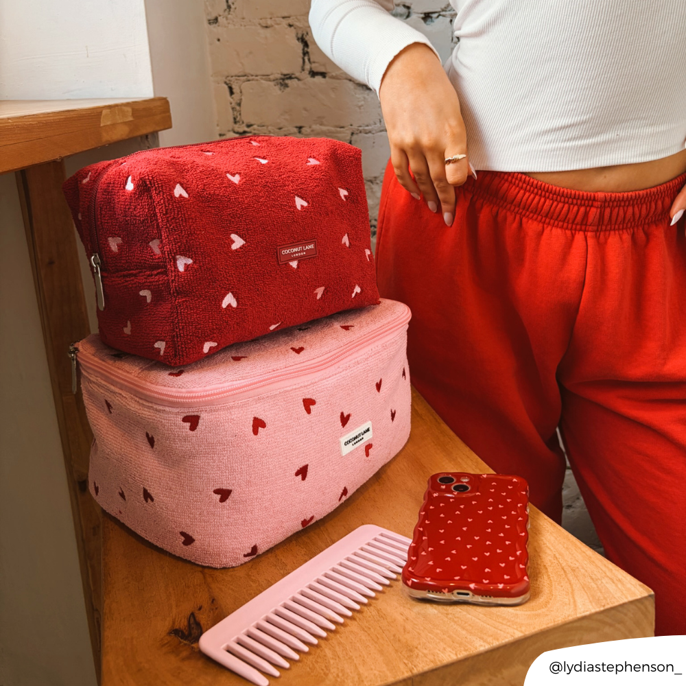 Girl stood next to her pink heart vanity case