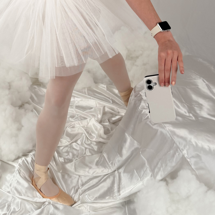 A white background and girl wearing tutu holding the Cloud Dancer Tough Phone Case