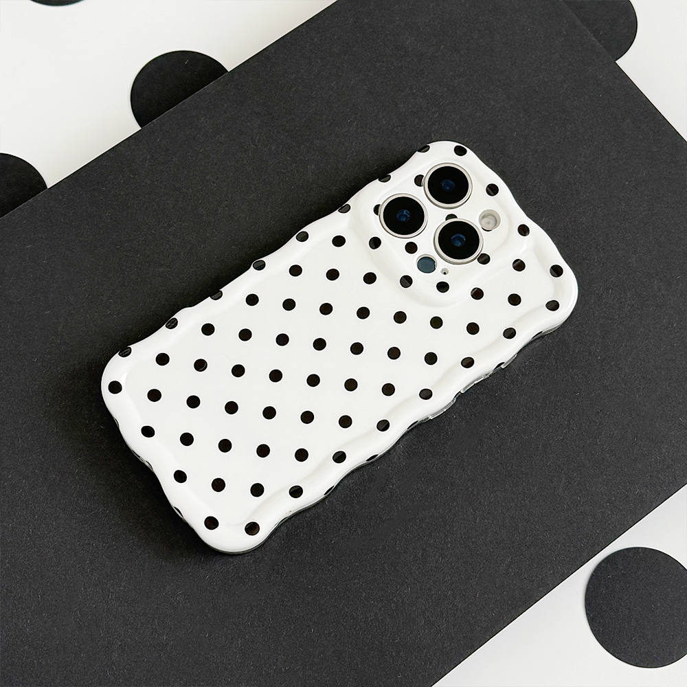 Coconut Lane wavy phone case with white polka dots on a bold black background.