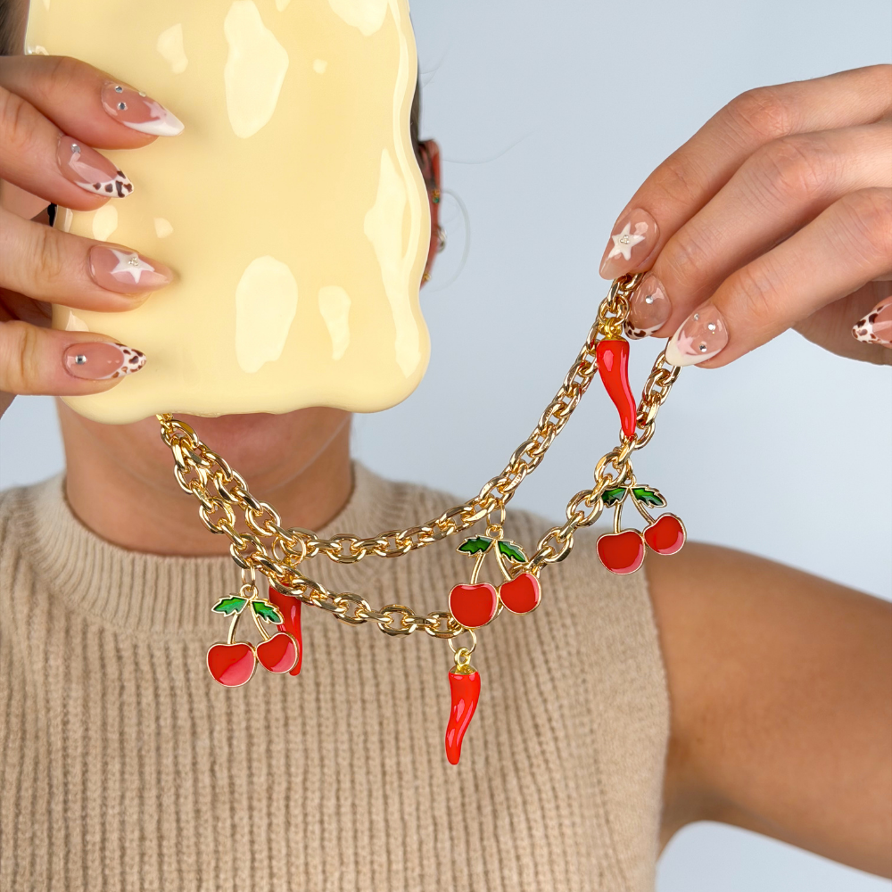Girl holding cherry spice phone strap close up image in studio 