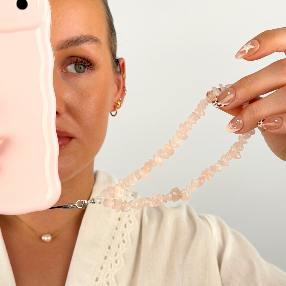 Close up of the rose quartz phone strap