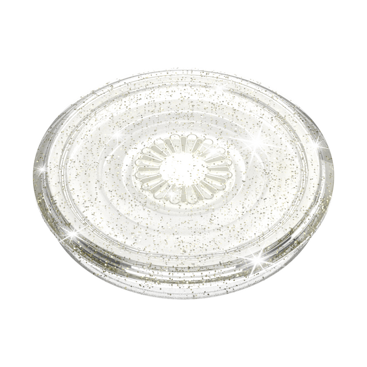 The PopSocket Grip - Clear Silver Glitter by Coconut Lane is a circular, translucent plastic lid adorned with a glittery, sparkly design. It boasts a raised, sunburst-like pattern in the center and has a smooth outer edge. Shimmering reflections dance across its Clear Silver Glitter surface.