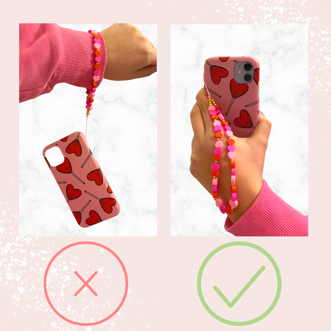 Split image showing a hand holding an iPhone with a heart-patterned case and beaded wrist strap. Left: The phone is detached from the Crystal Phone Strap - Green by Coconut Lane (wrong, marked with an X). Right: The hand grips the Crystal Phone Strap - Green securely with added phone charms (correct, marked with a check).